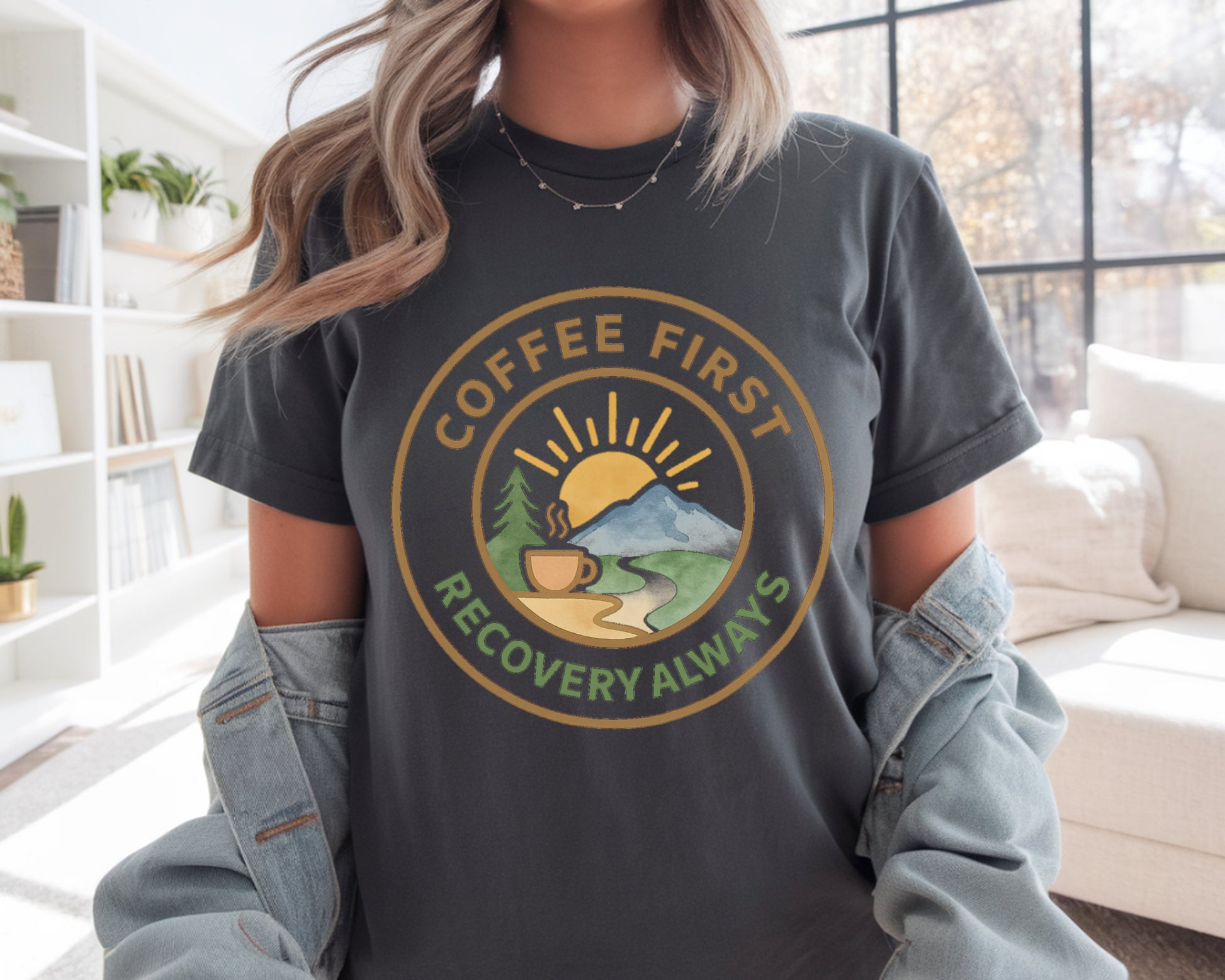 Person wearing a dark gray t-shirt with 'Coffee First, Recovery Always' graphic design.