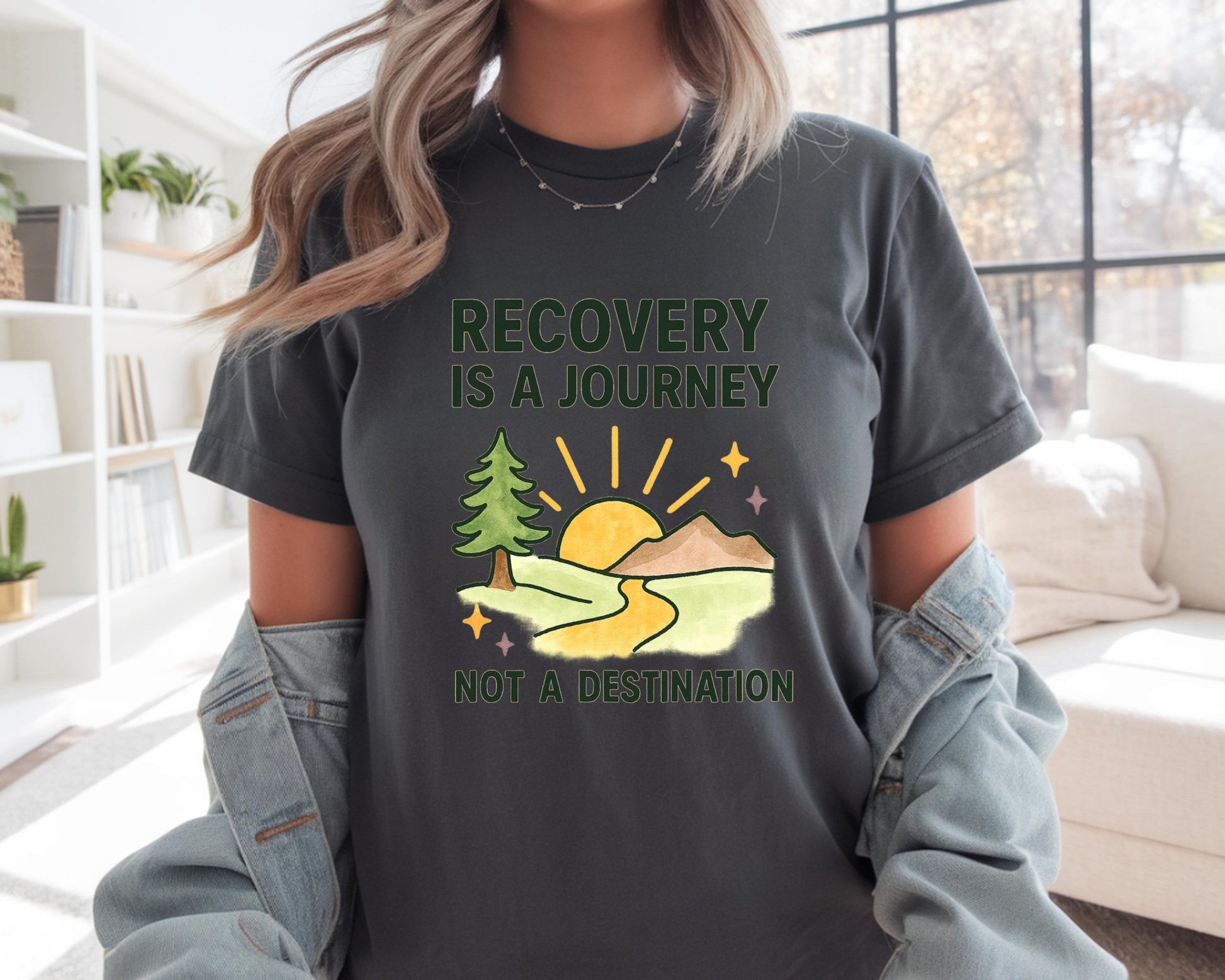 Person wearing a t-shirt with 'Recovery is a Journey, Not a Destination' graphic in a home setting.