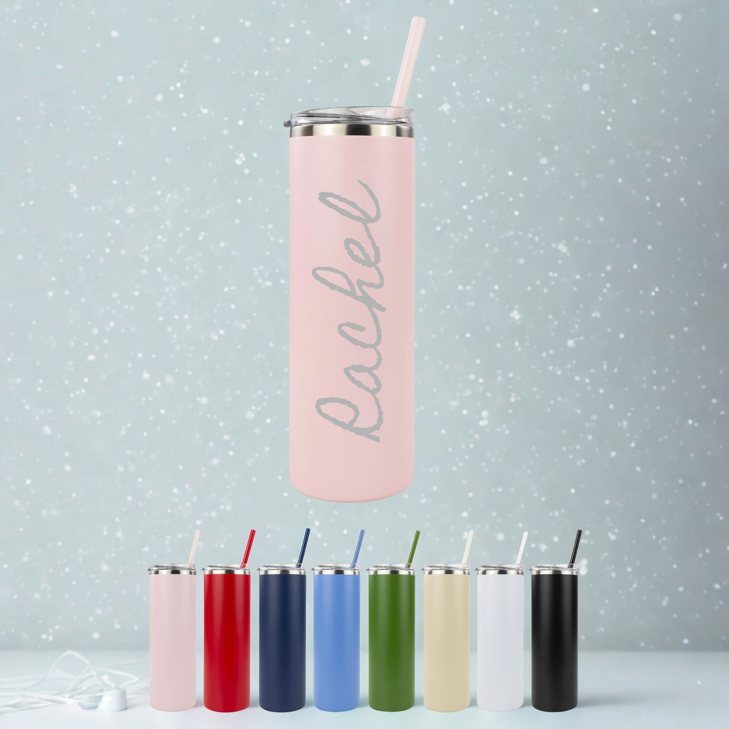 Pink tumbler with engraved name on a light gray background