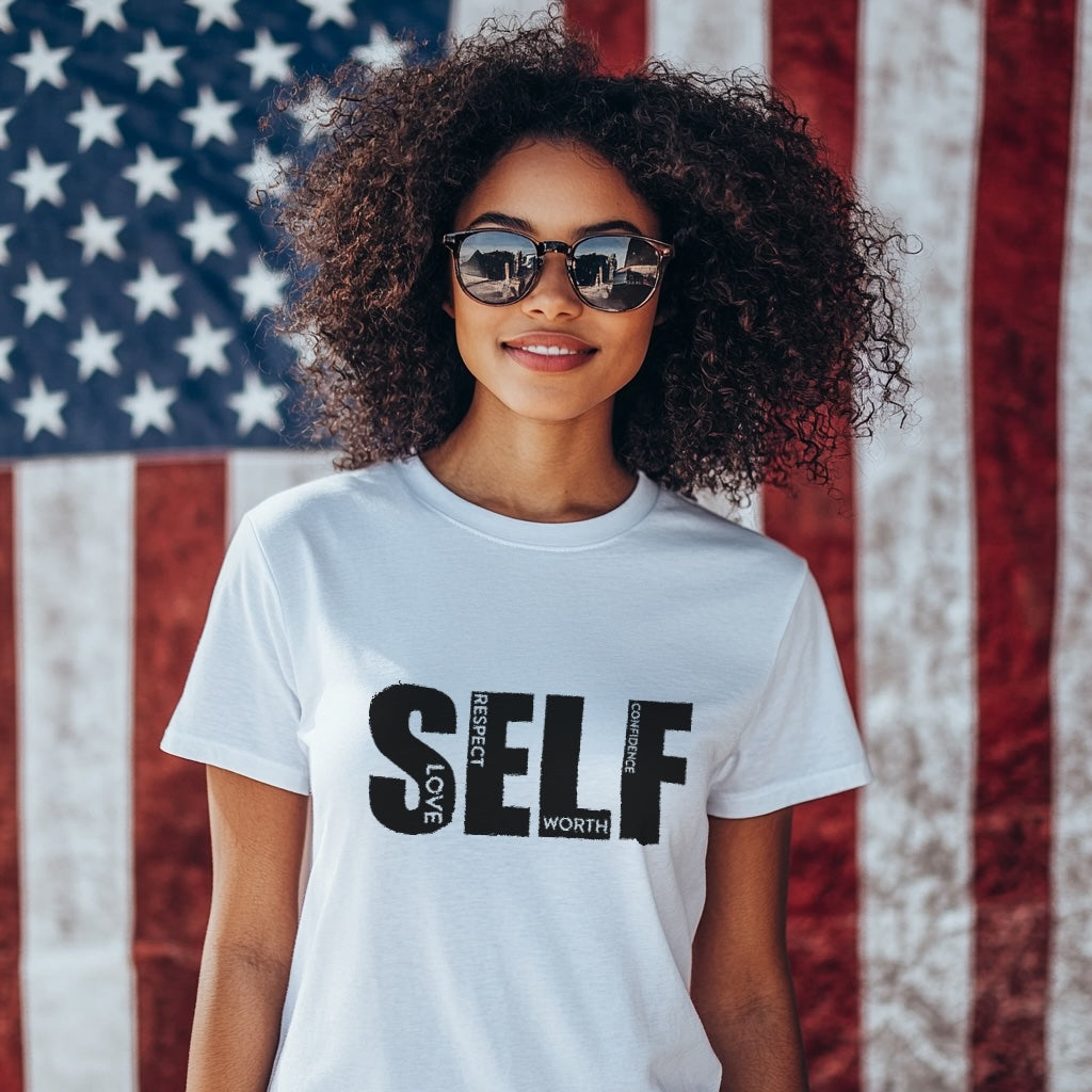 Person wearing a white t-shirt with 'SELF love respect worth confidence'  text in front of an American flag.