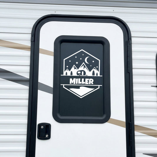 Personalized camping badge name decal applied to RV door