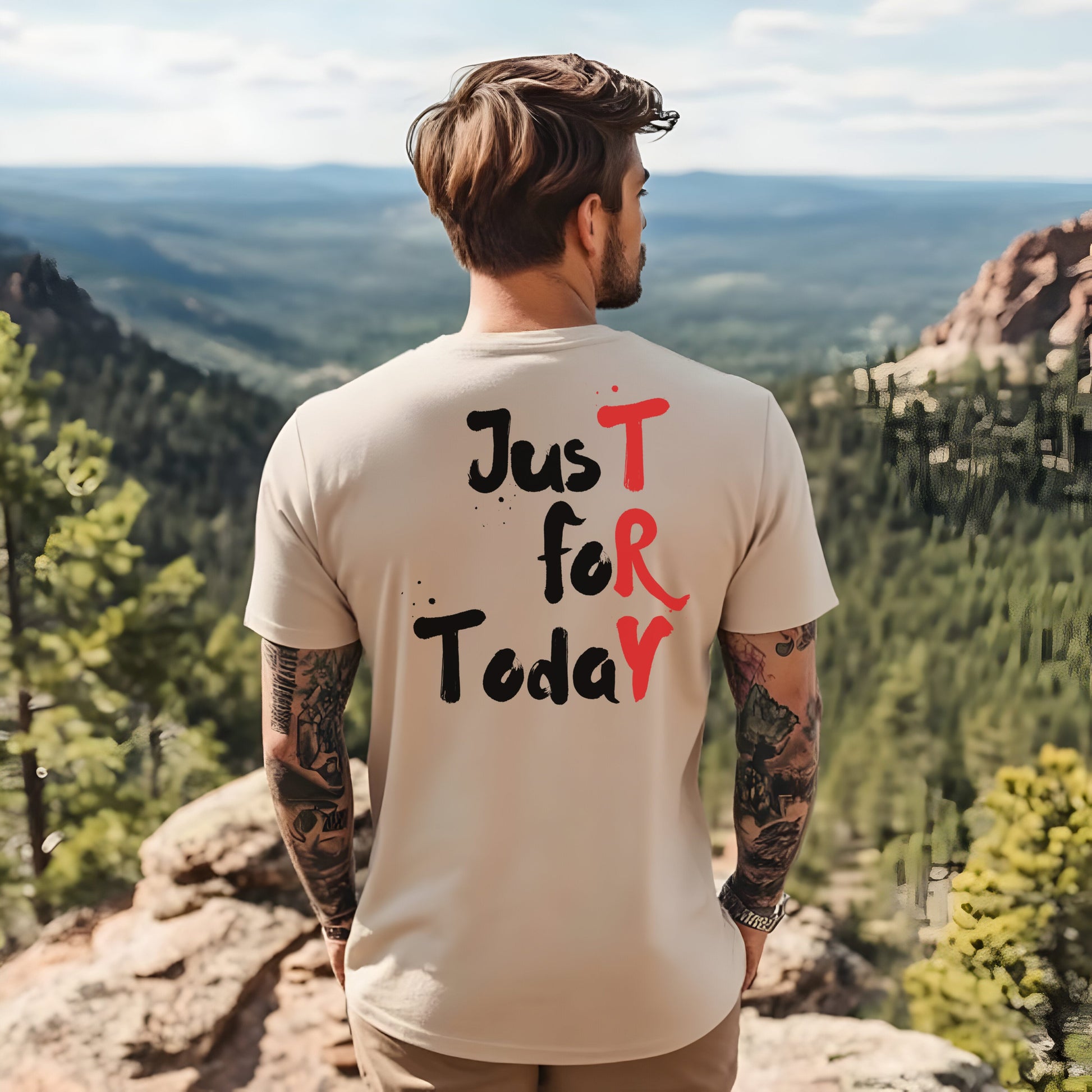 Man wearing a t-shirt with 'Just for Today' text in a scenic outdoor setting