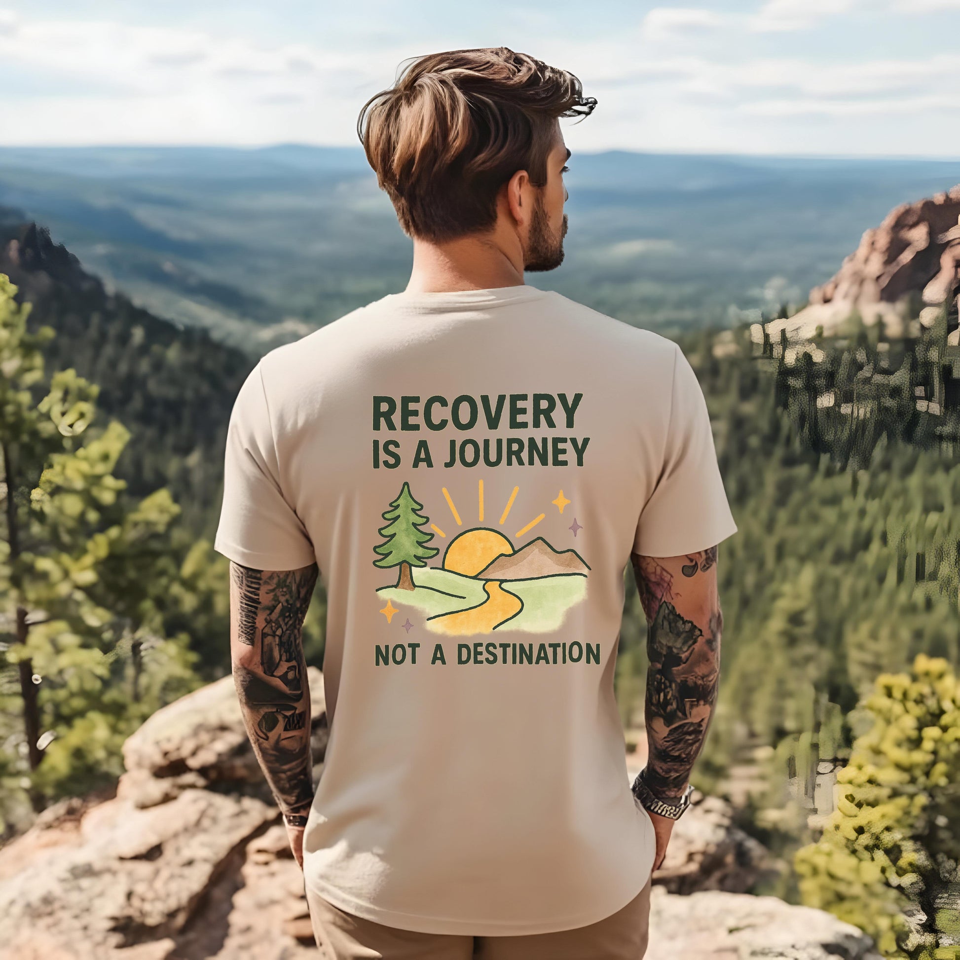 Man wearing a t-shirt with 'Recovery is a Journey, Not a Destination' design on a mountainous landscape.