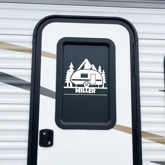 Personalized rounded camper trailer name decal applied to RV door