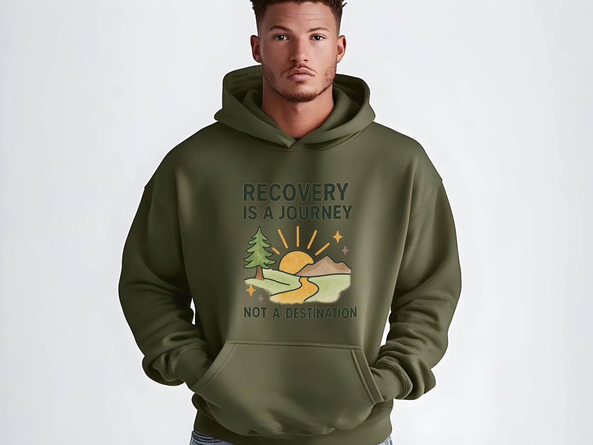 Man wearing a green hoodie with  'Recovery is a Journey, Not a Destination' and nature graphic on a white background