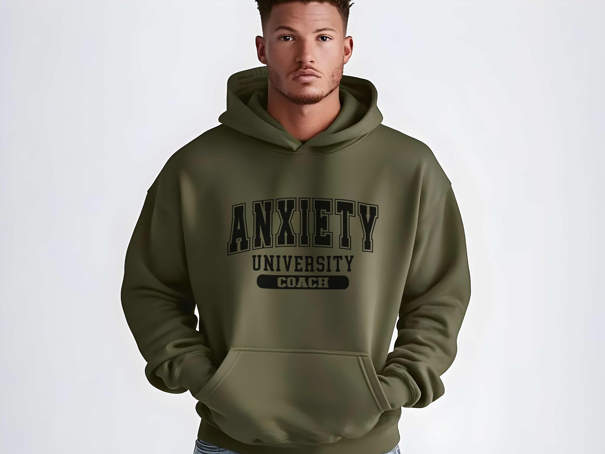 Person wearing a green hoodie with 'Anxiety University Coach' text on a white background