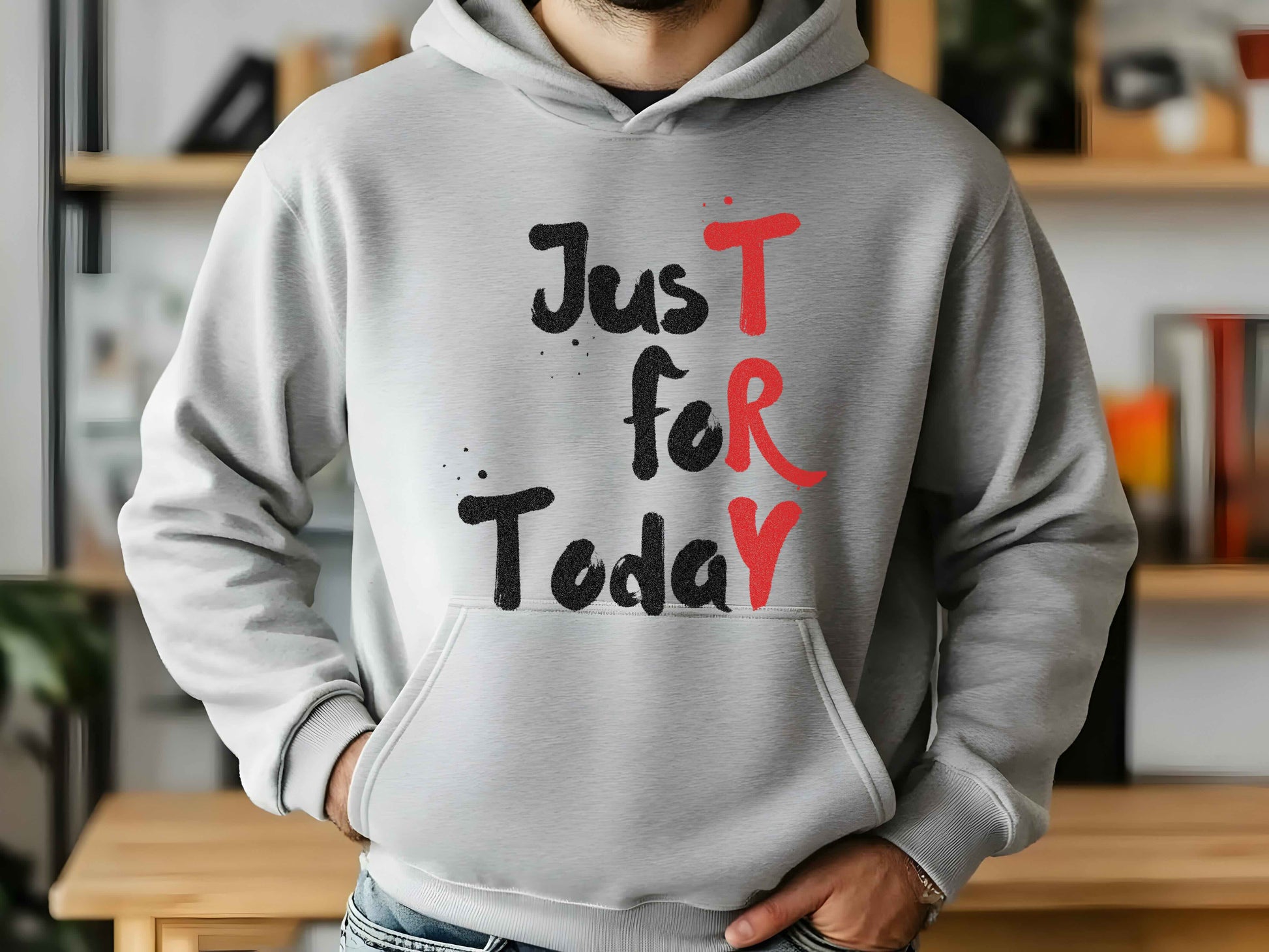 Person wearing a gray hoodie with 'Just For Today' text in black and red.