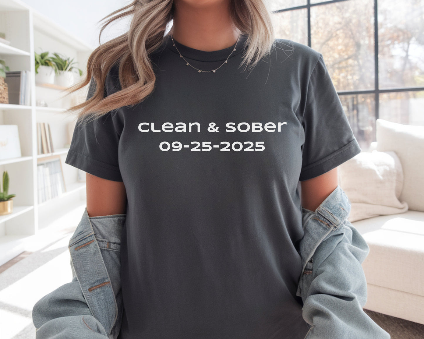 Person wearing a t-shirt with 'clean & sober' text in a living room setting