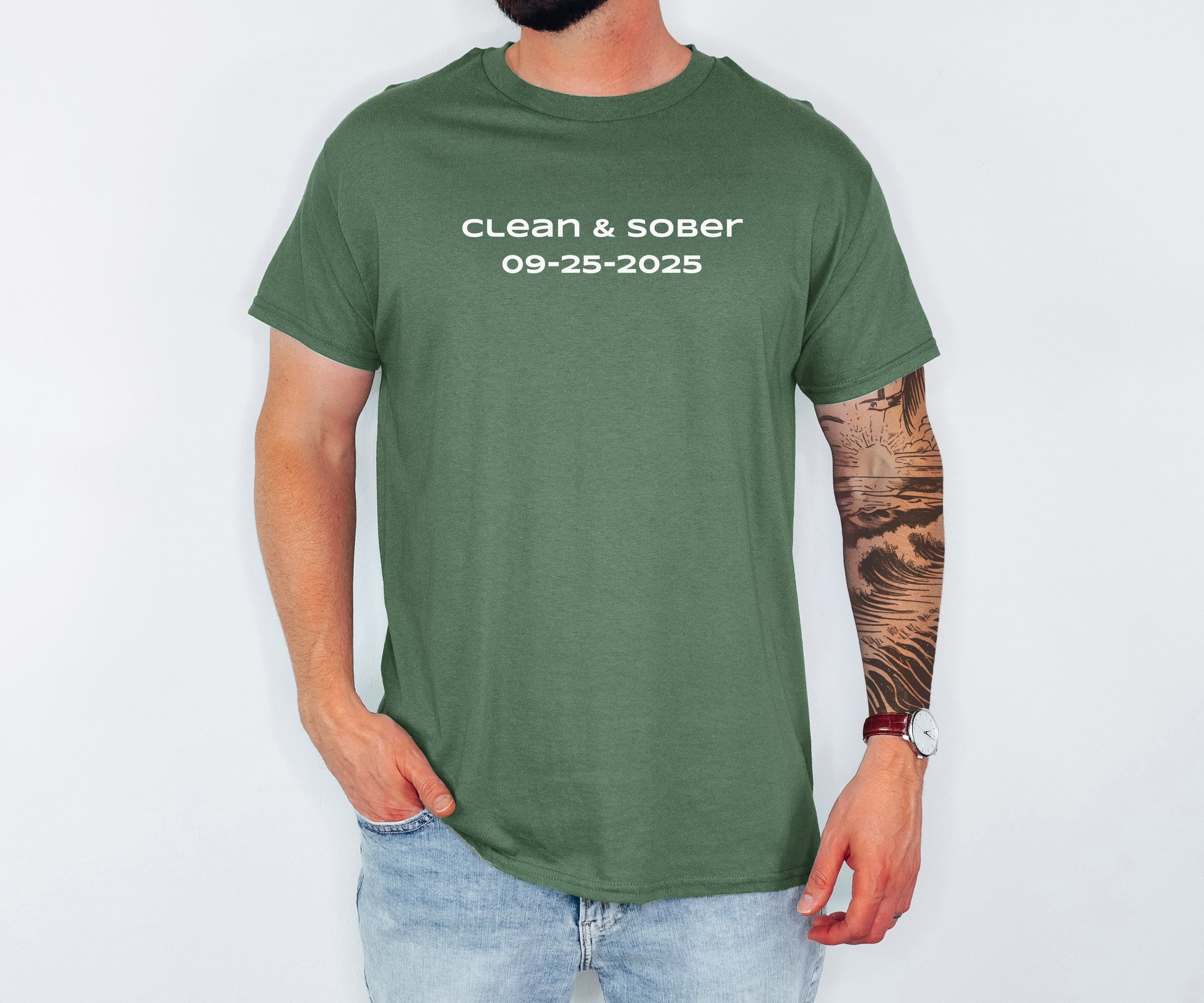 Person wearing a green t-shirt with 'clean & sober 09-25-2025' text on a white background