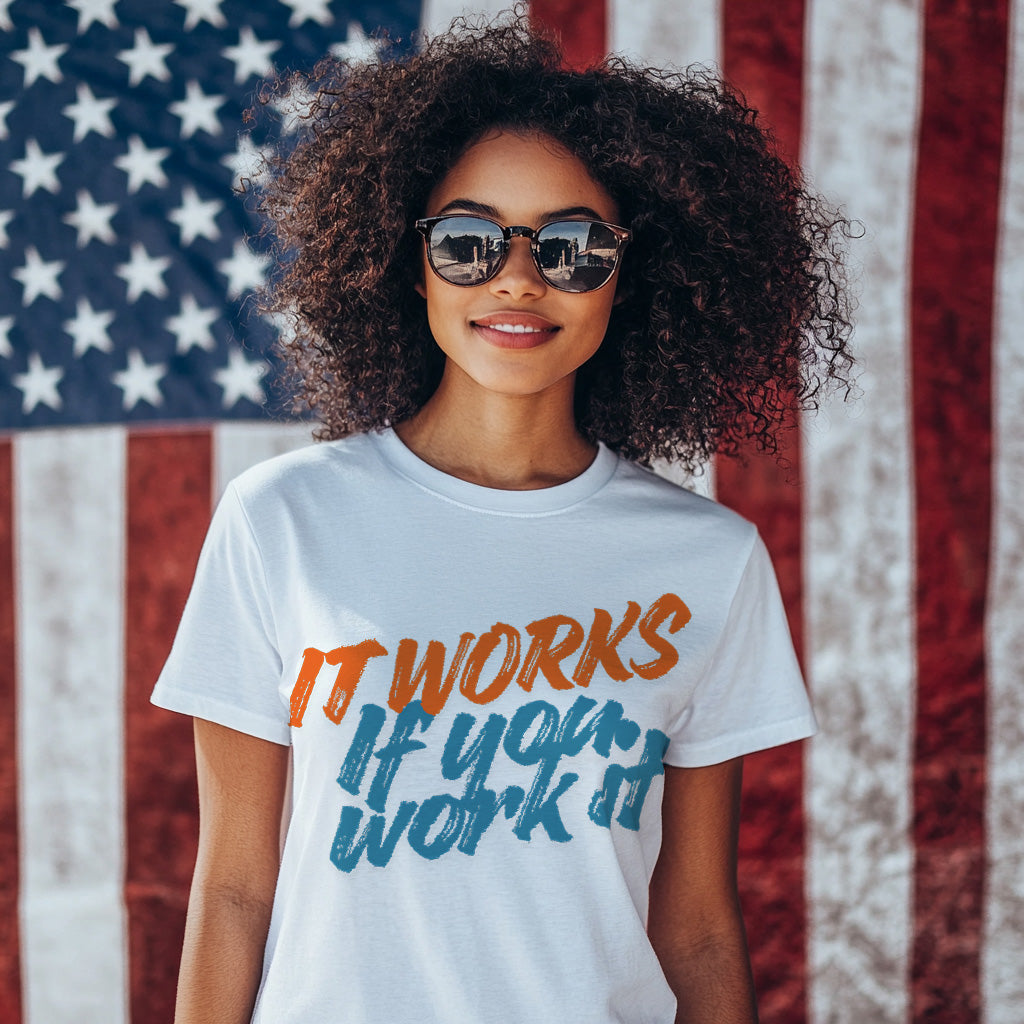 Person wearing a t-shirt with "It works, if you work it"in front of an American flag