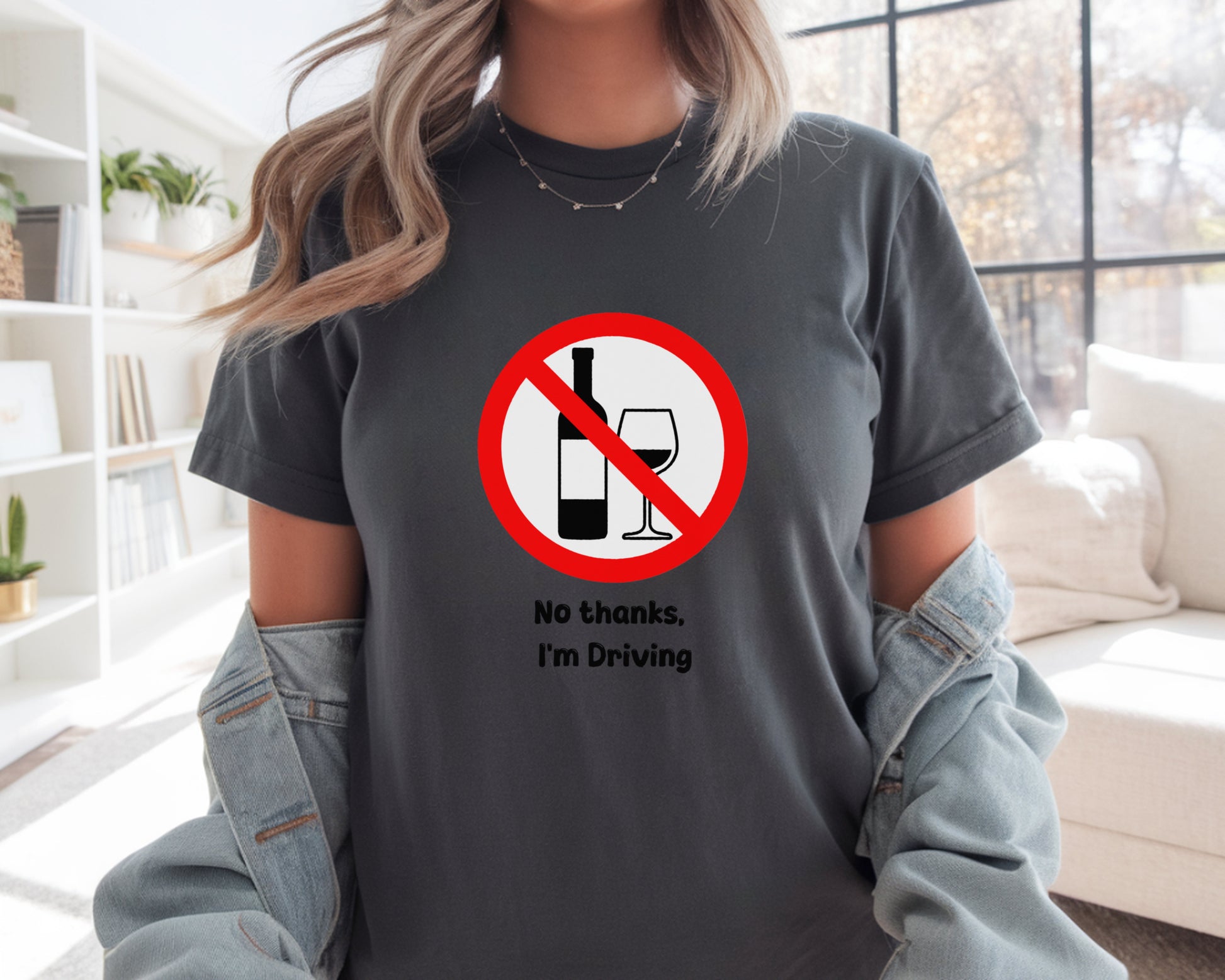 Person wearing a t-shirt with a no drinking while driving symbol and text.