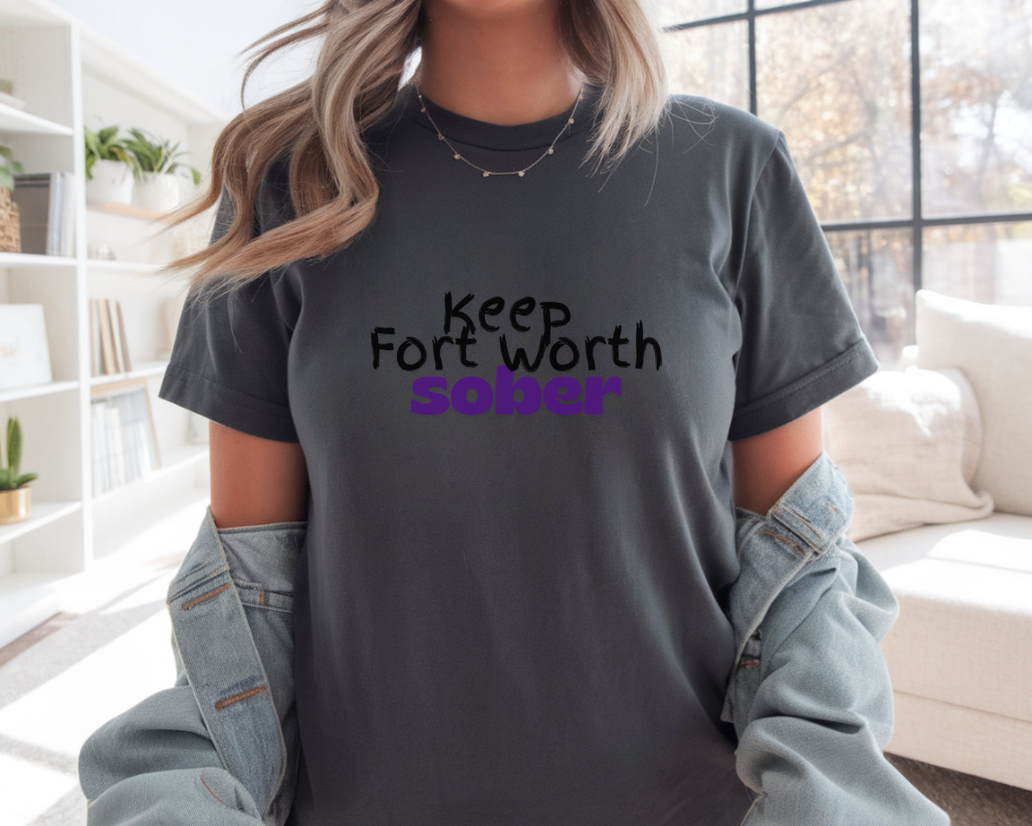Person wearing a t-shirt with 'Keep Fort Worth Sober' text in a casual setting.