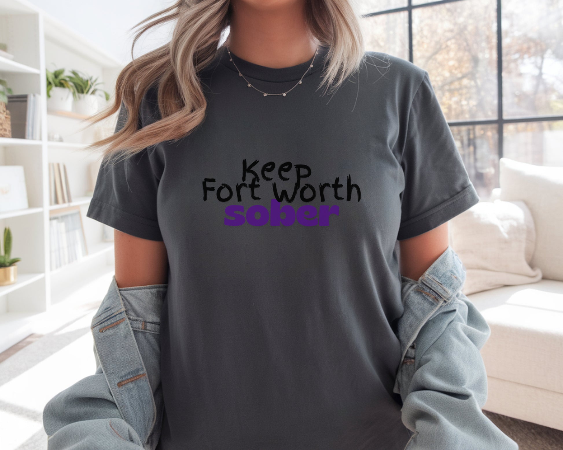 Person wearing a t-shirt with 'Keep Fort Worth Sober' text in a casual setting.